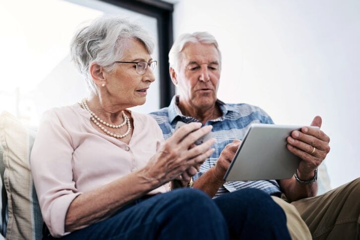 senior couple with calculator and notepad