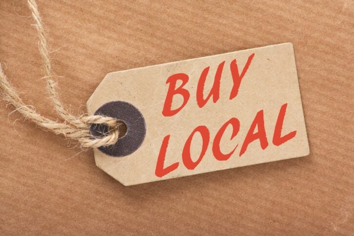 'Buy Local' written on a brown paper price tag