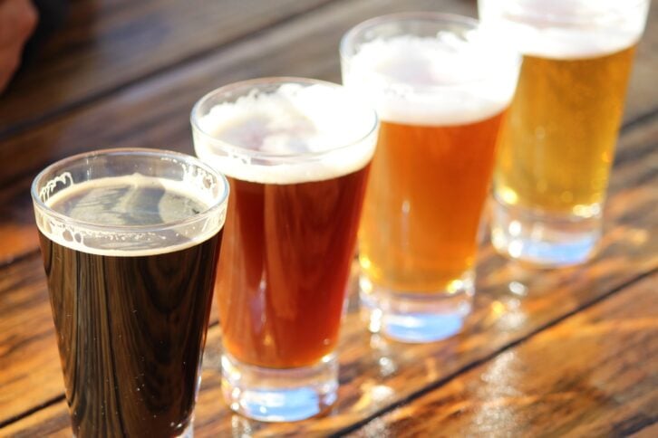 selection of four craft beers during a tasting session on a wooden table