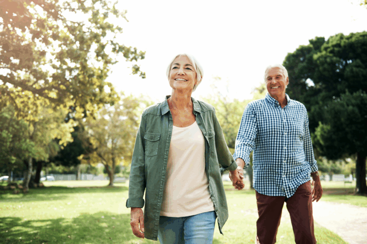 Happy and peaceful senior couple walking outside
