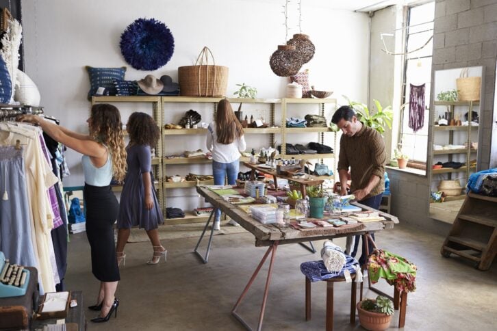 customers and staff in a busy clothes shop