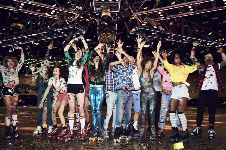 group of friends celebrating at roller disco