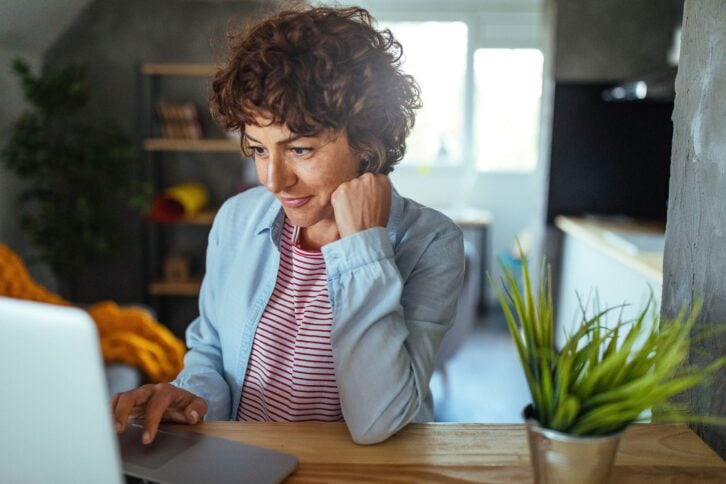 middle-aged woman using a laptop at home