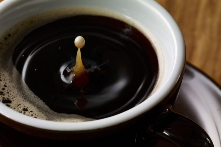 drop of milk in cup of coffee