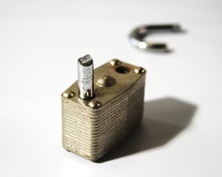 close up of a broken lock with broken part out of focus