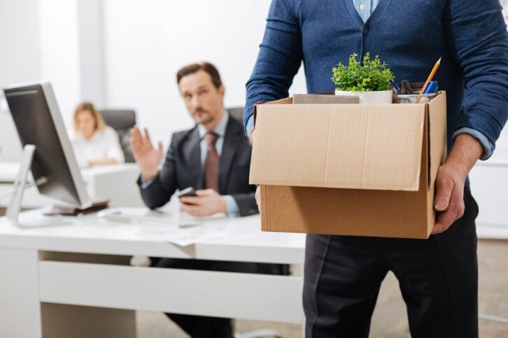 fired senior employee leaving the office with the box