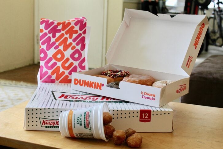 Krispy Kreme and Dunkin' Donuts doughnuts with boxes and bag