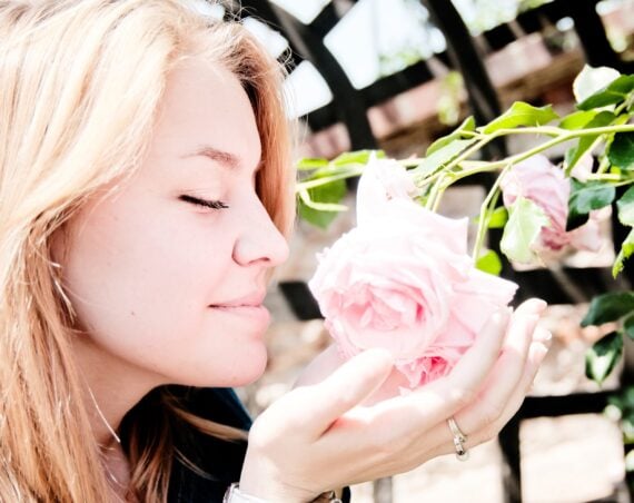 woman smelling a rose