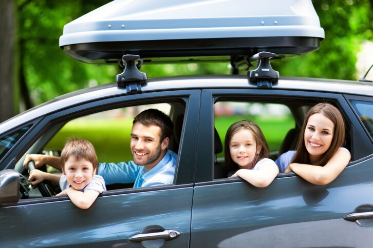 happy family sitting in the car