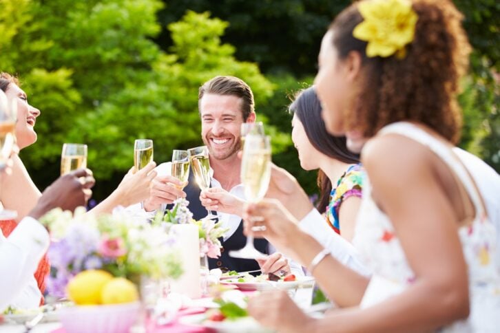 group of friends enjoying outdoor dinner party