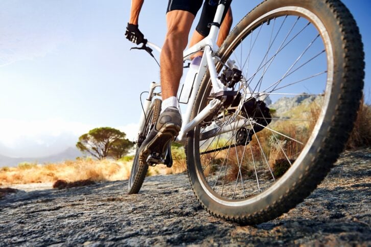 man riding mountain bike on trail