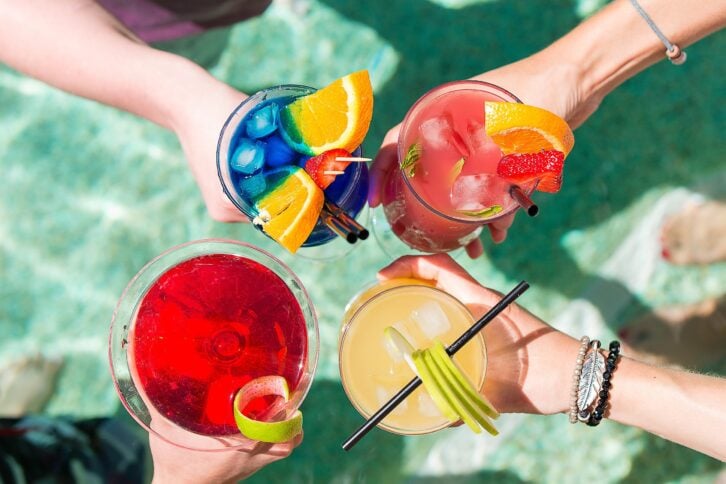 four summer cocktails in four hands at the pool