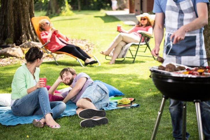 people outside enjoying a cook out