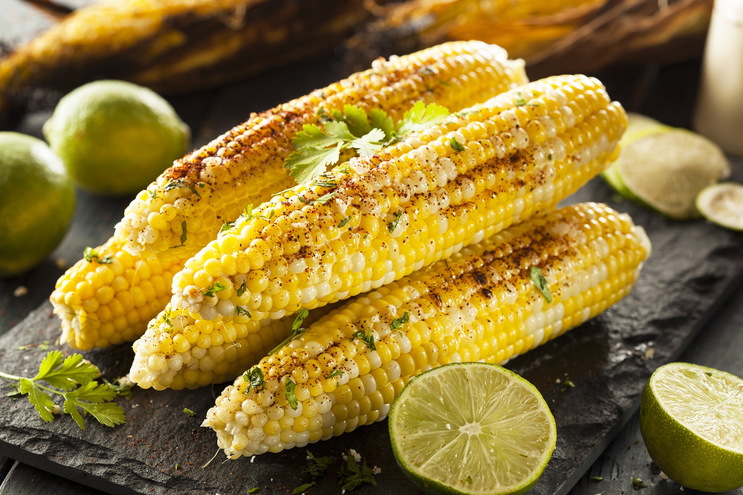 Slightly blackened Corn on the Cob Garnished with Pepper and Lime