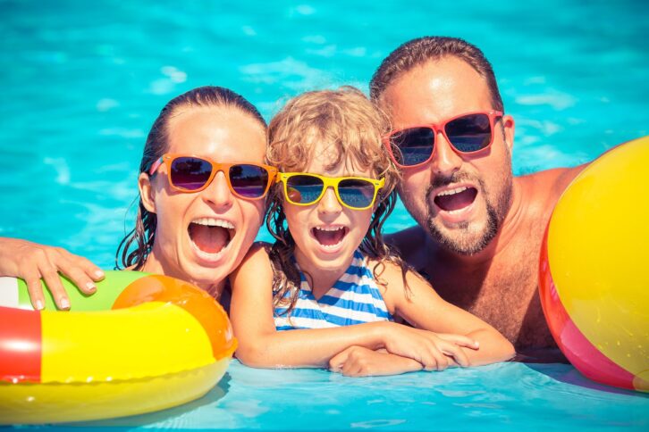 family in the water of a pool