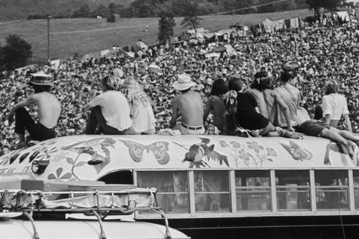 fans sitting on top of a painted bus at the Woodstock Music Festival, Bethel, New York, 15th-17th August 1969