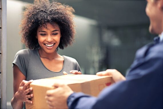 woman receiving package from delivery man