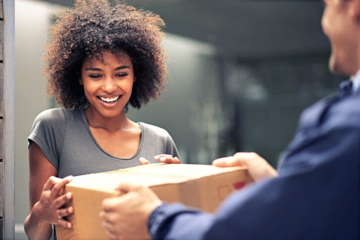 woman receiving package from delivery man
