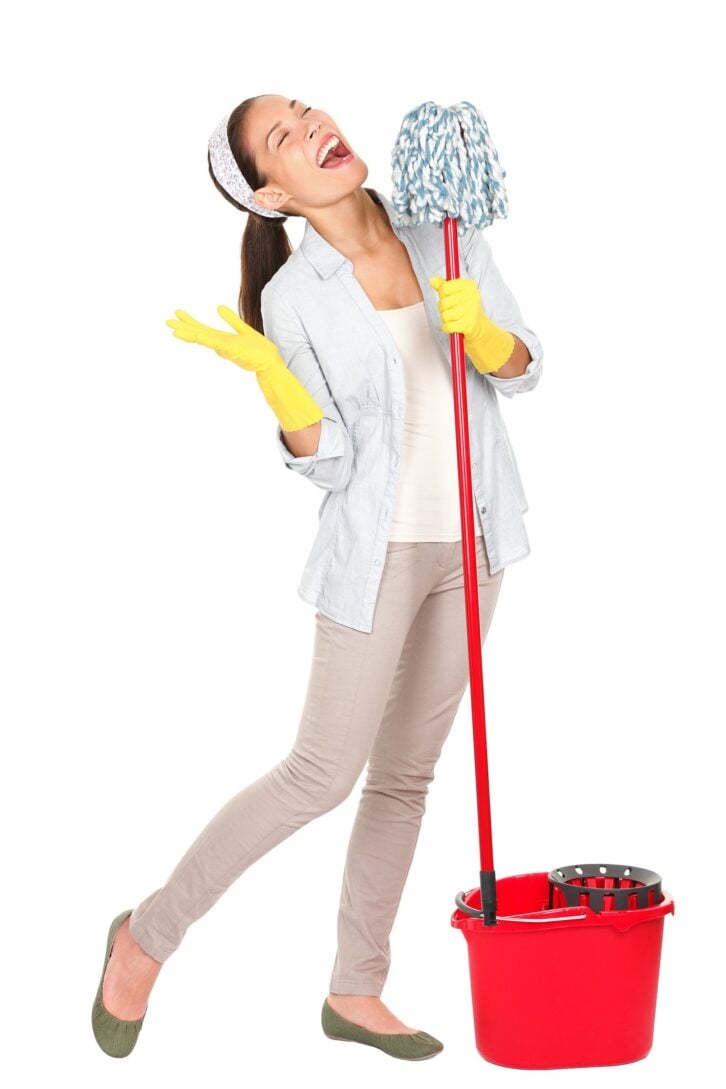 young housewife having fun doing chores with cleaning mop and bucket