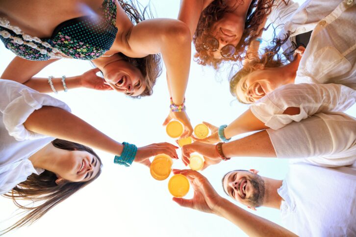 group of friends cheering glasses of beer