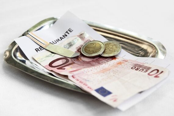 restaurant bill and money on metal tray