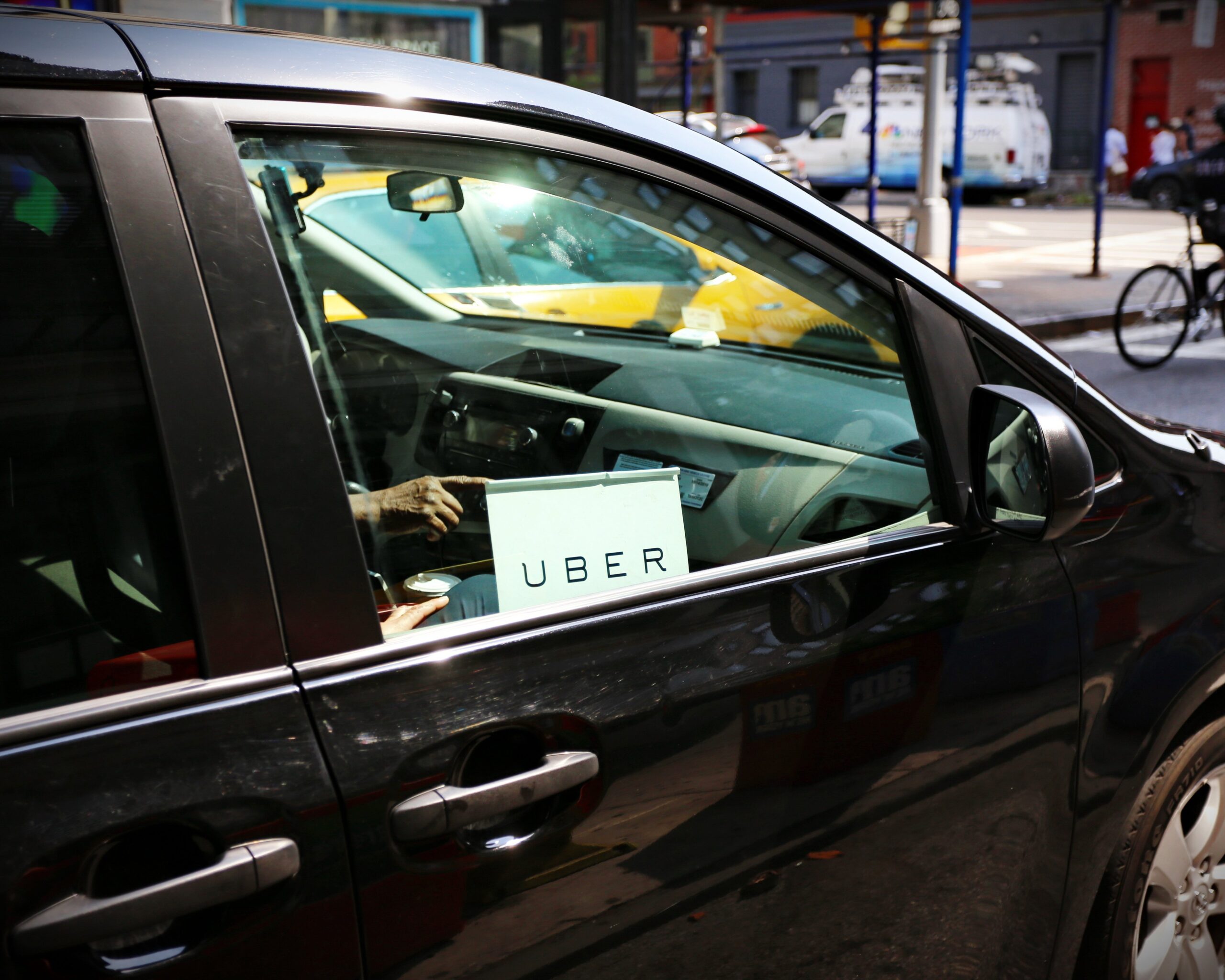 uber sign on car window