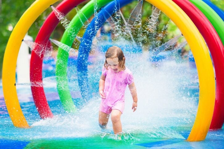 little girl in a splash pad