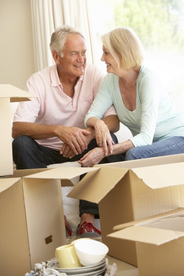 senior couple moving home and packing boxes