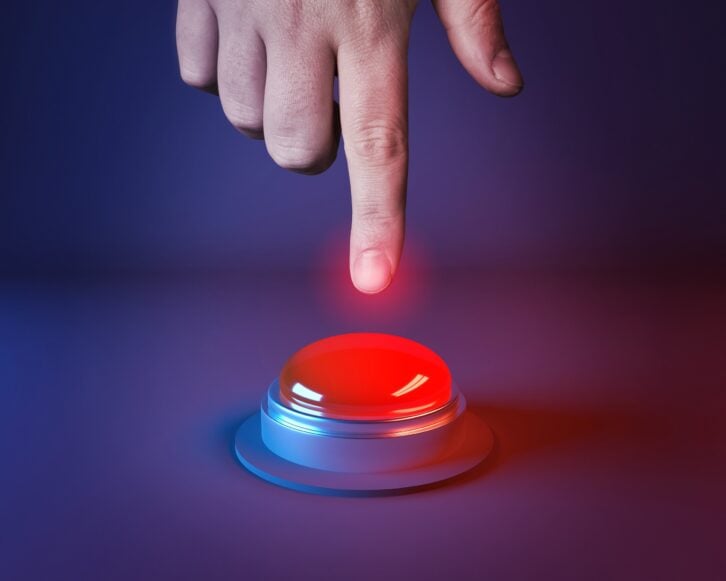 person about to press a big red button
