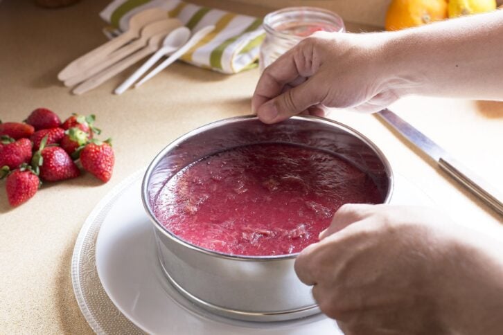 man hand removing from its mold of cheesecake