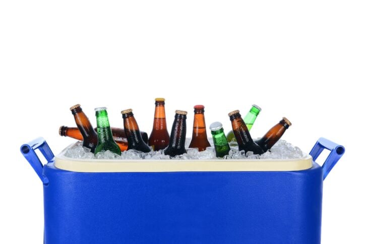 Closeup of an ice chest full of ice and assorted bottles