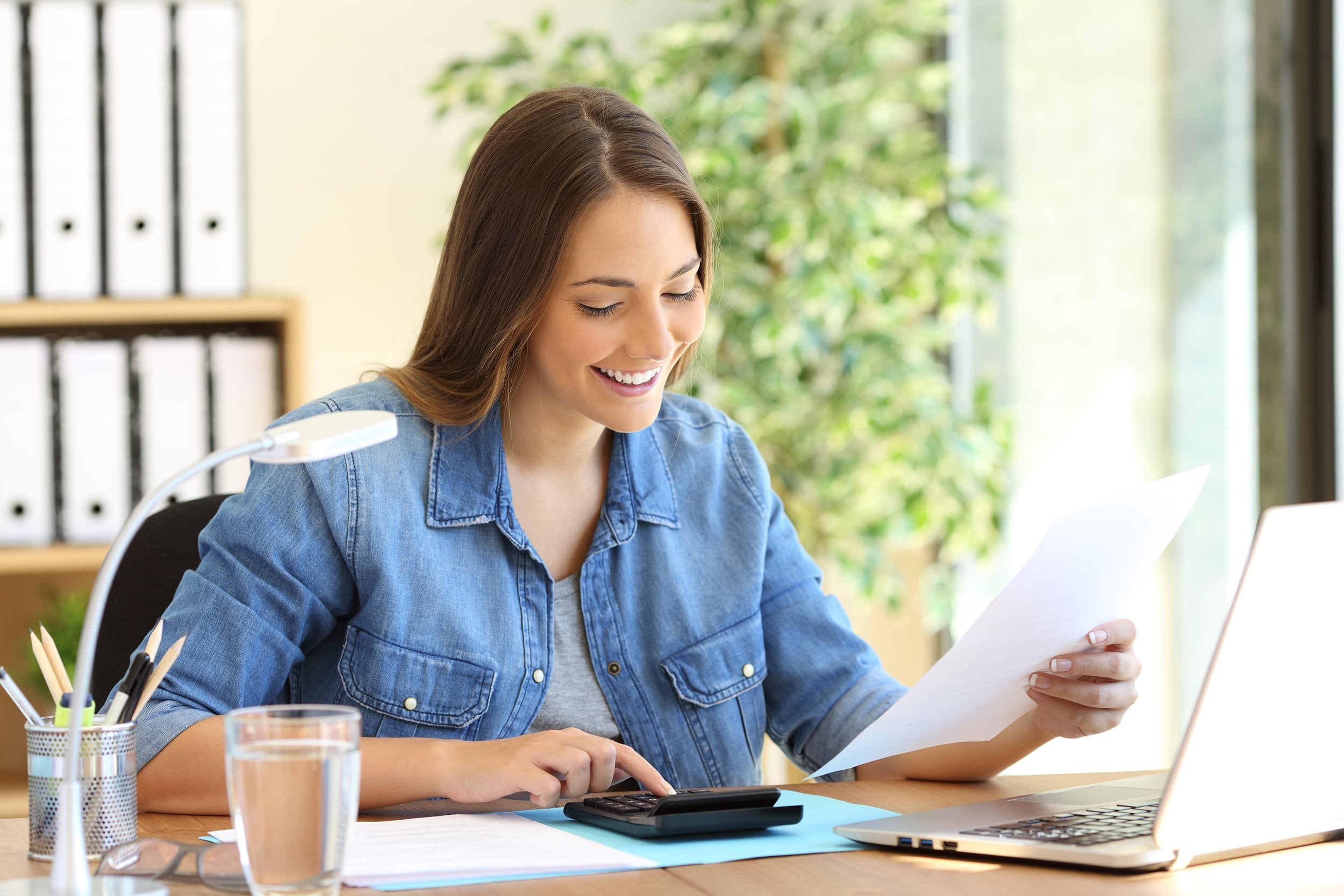 woman calculating a budget in a desktop at home office