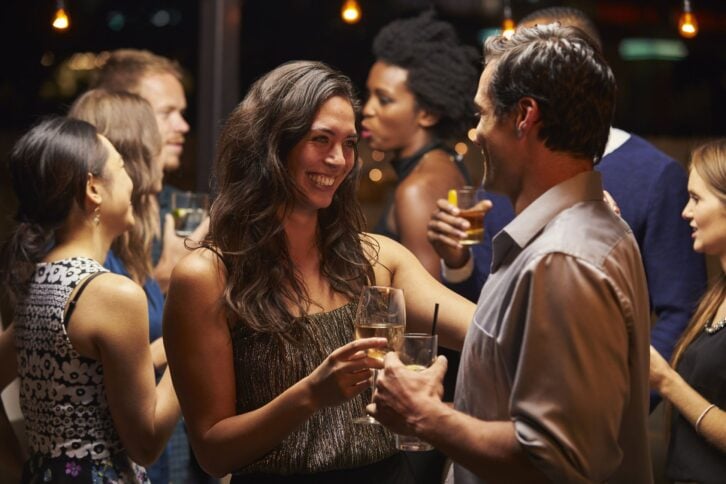 couples dancing and drinking at evening party