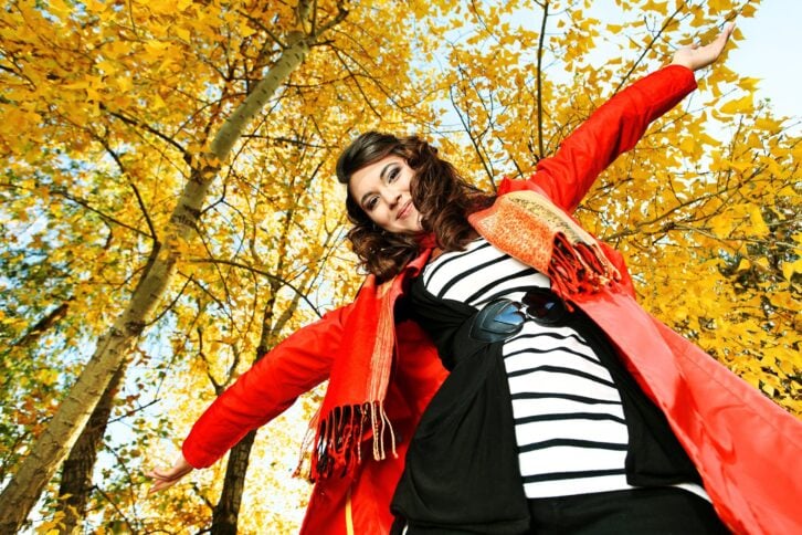 Happy fashionable woman in a park during autumn