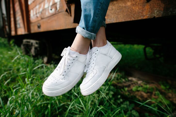 woman wearing white sneakers