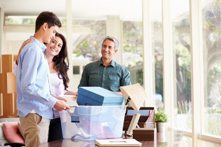 parents helping teenage son pack for college