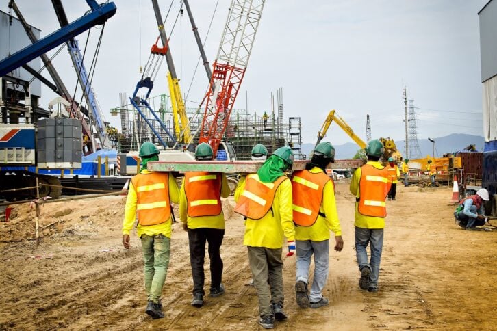 Shot of construction workers walking away on a construction site