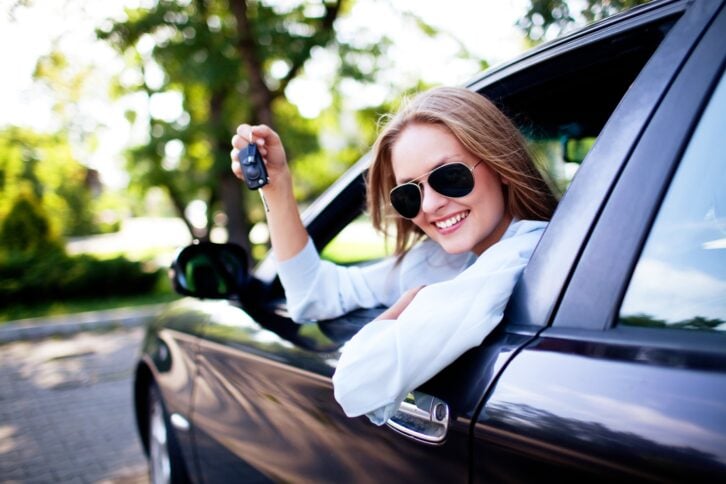 woman shows the keys to her new car