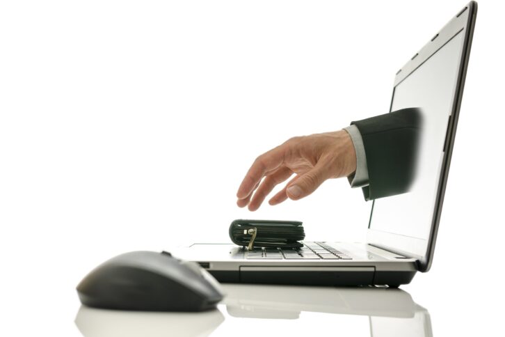 hand coming out of laptop screen stealing wallet