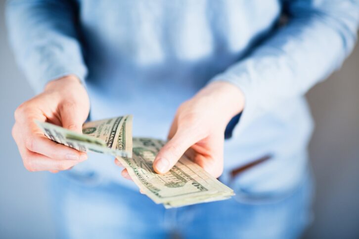 female hands paying in cash
