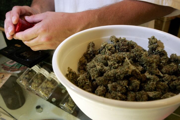 A worker at the Alternative Herbal Health Services cannabis dispensary packages medicinal marijuana July 13, 2006 in San Francisco.