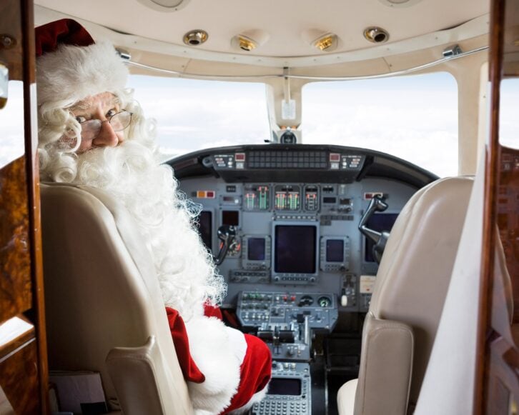 portrait of Santa sitting in cockpit of private jet