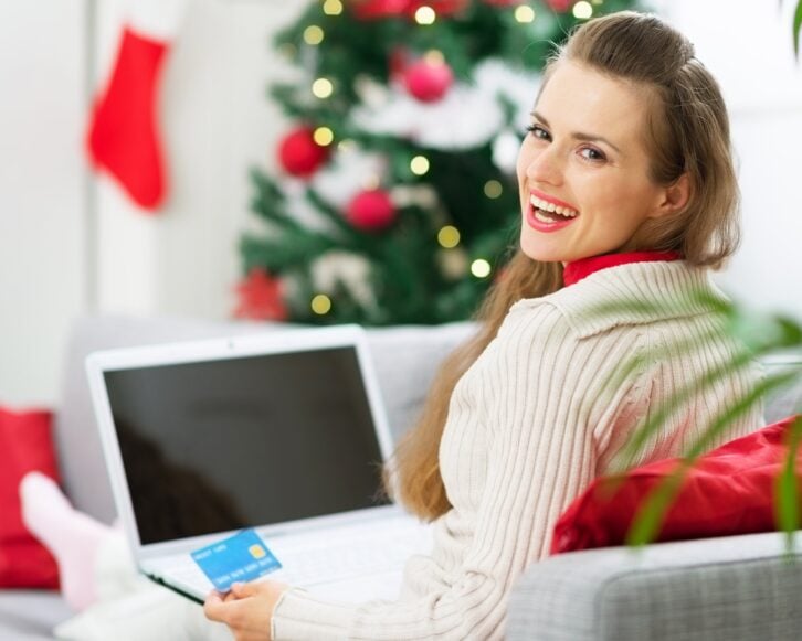 smiling woman making Christmas shopping on internet