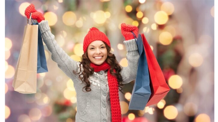 Happy woman holiday shopping and holding bags