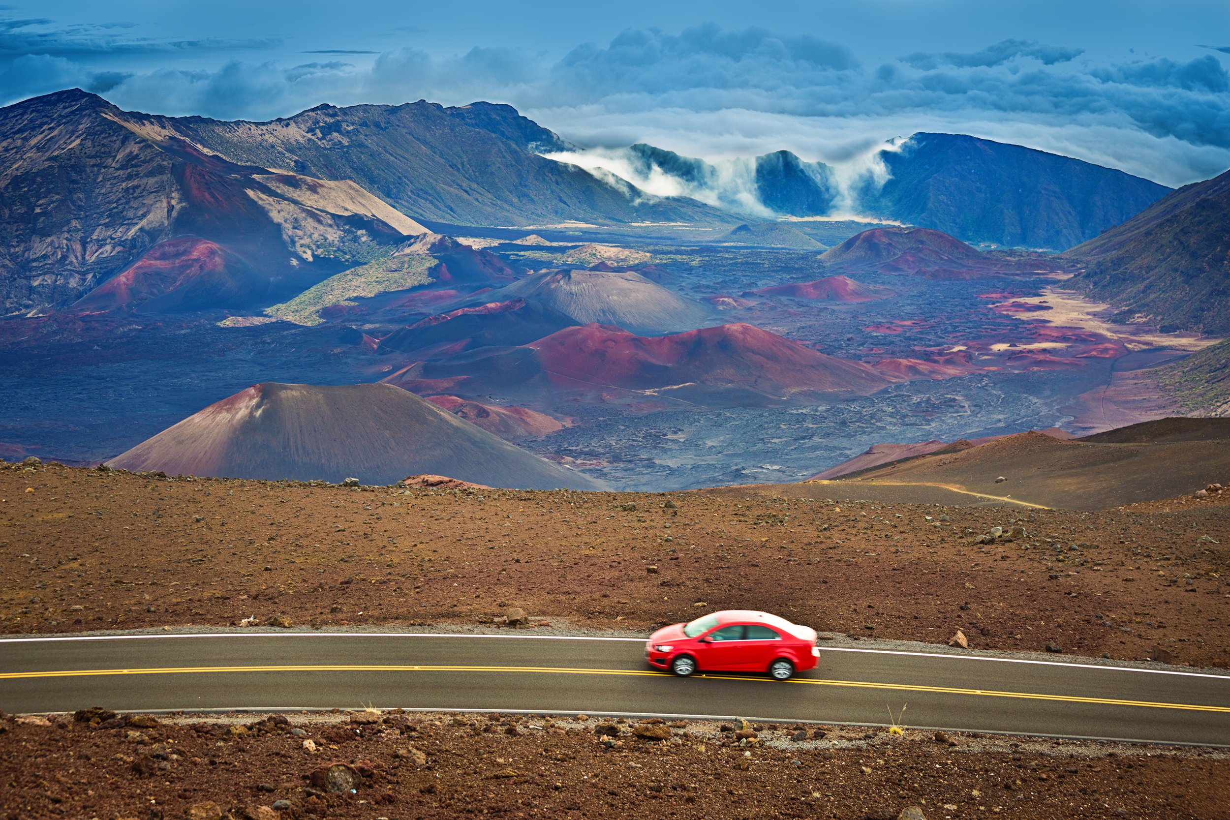 car at Haleakala Crater during sunrise in Maui Hawaii