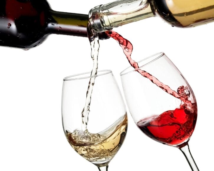 red and white wine flow in two glasses