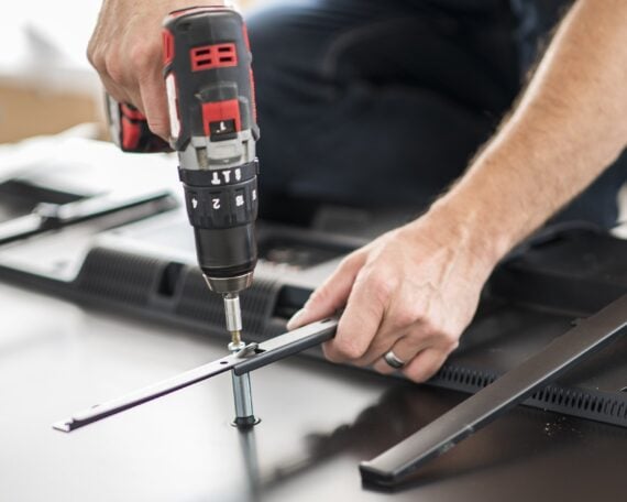 man using cordless drill