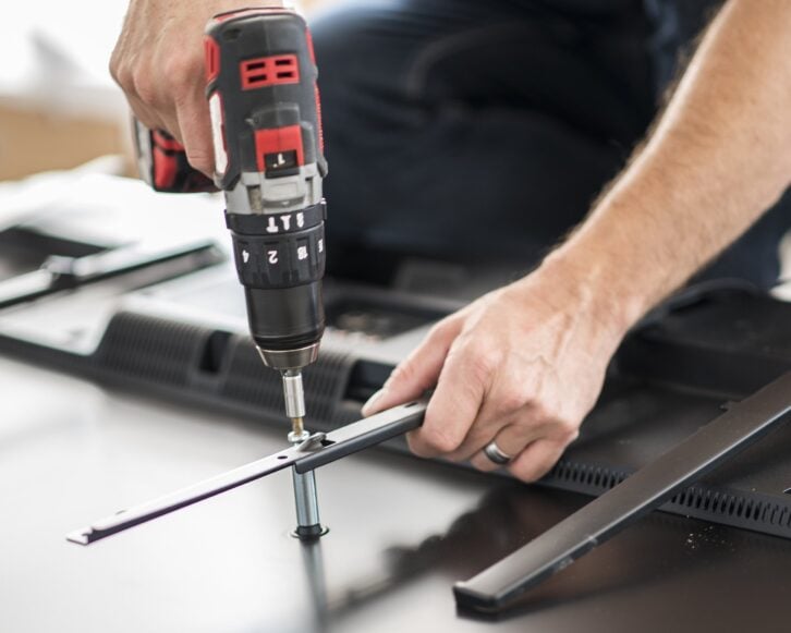 man using cordless drill