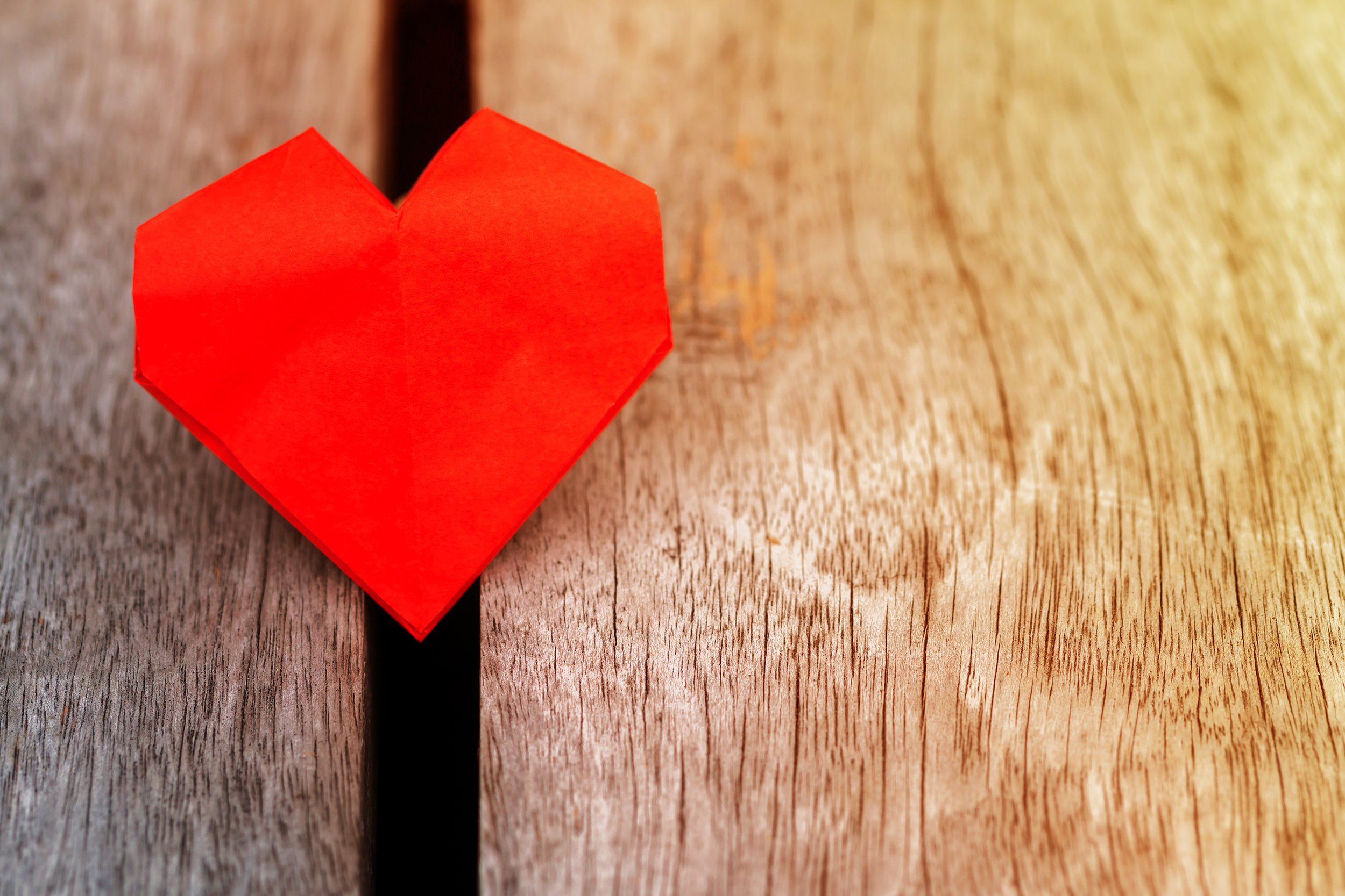 paper red heart on the wooden background