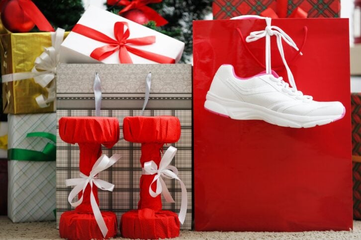 running shoes dumbbells presents under the Christmas tree